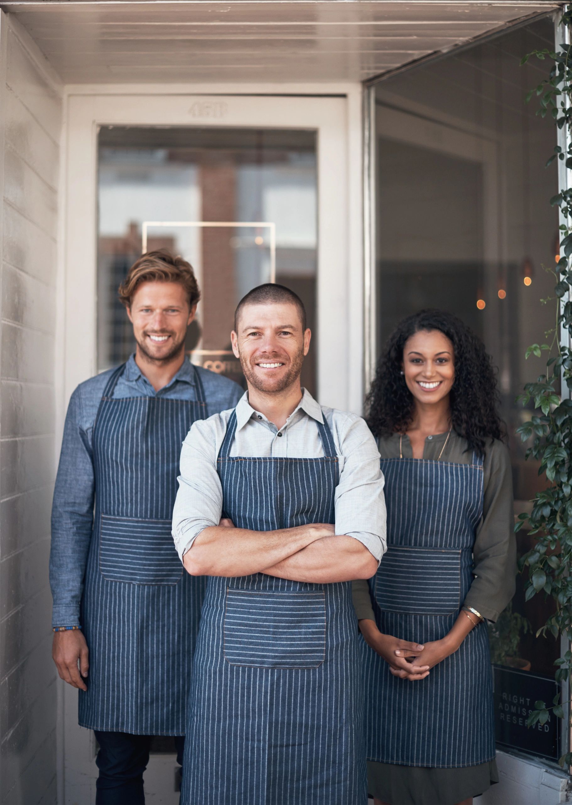 Group of café employees standing outside their shop