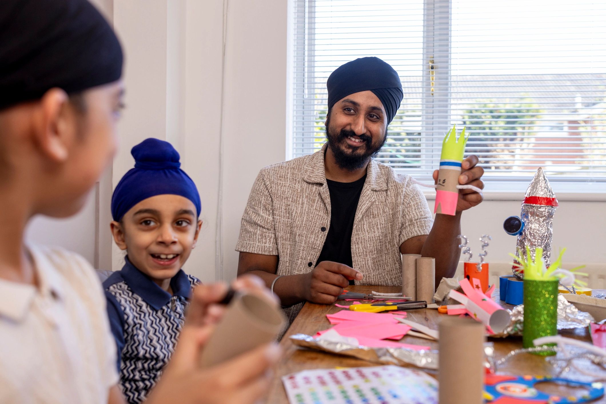 Family gathered around a table for a fun group activity