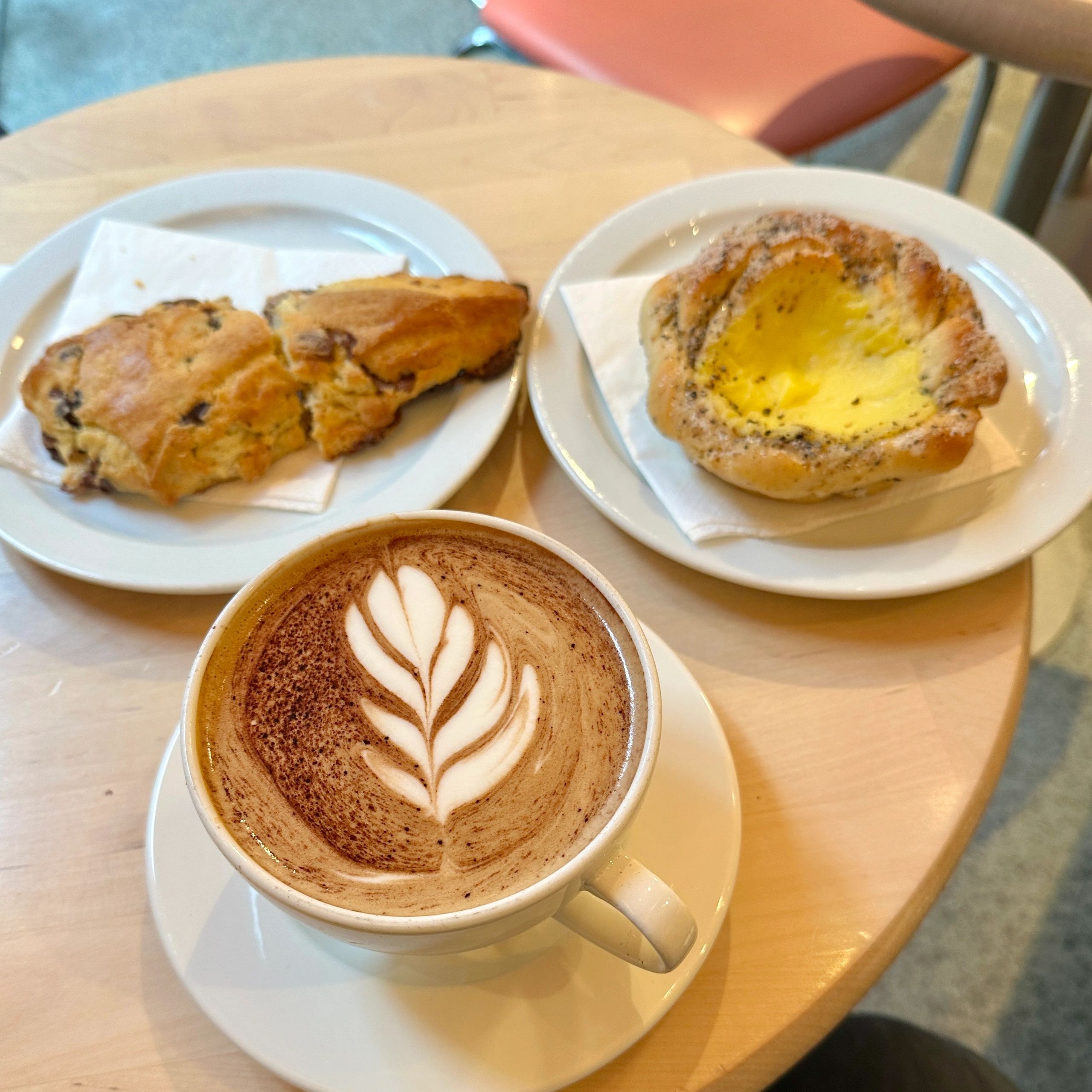 Latte and pastries on a cafe table